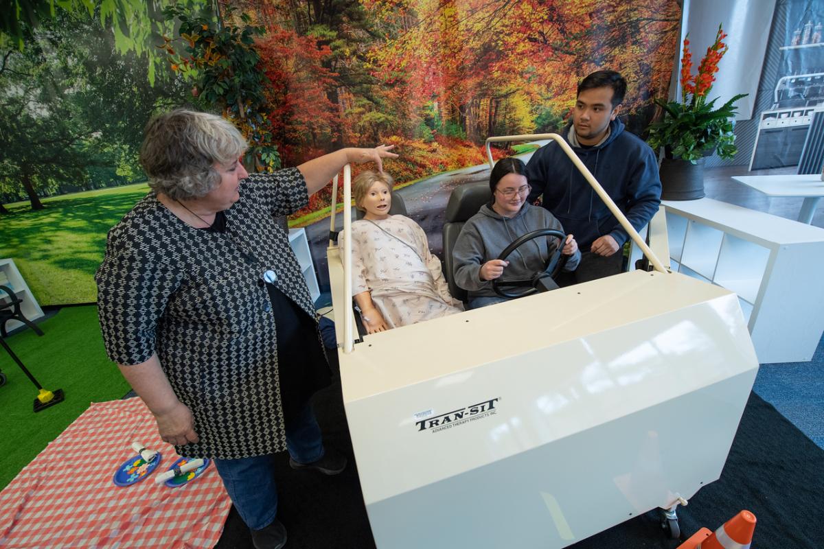 Occupational Therapy lab including students and a professor.