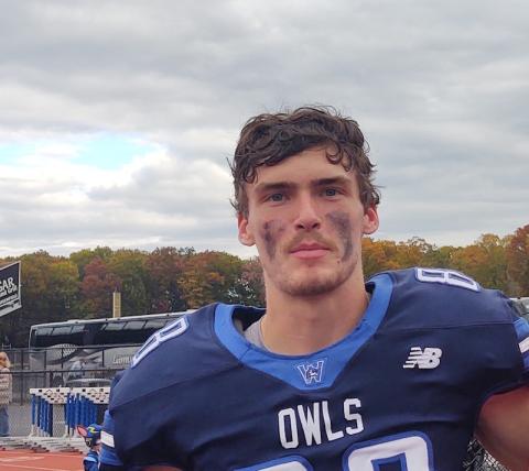 Will Brewster, a junior and football player at Westfield State. He's wearing his Owls uniform and has dark paint smudged on his face from a recent game.