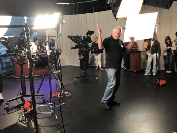 Mark St. Jean explains the complexities of television production in the studio in Ely Campus Center.