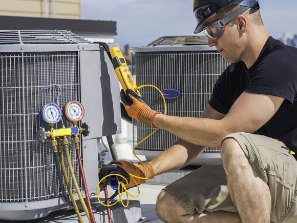 man working on central air unit