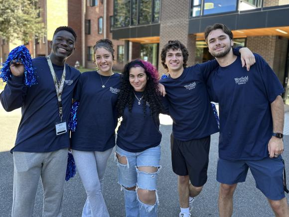 Madi Loik stands with fellow Westfield State Resident Assistants outside a campus residence hall.