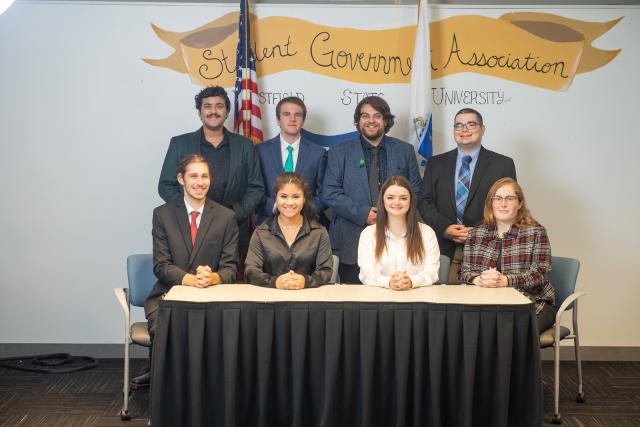 SGA Executive Council featuring 8 students with Student Government banner behind them.