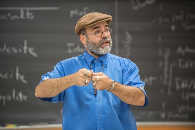 Professor Aaron Reyes teaching in classrooom.