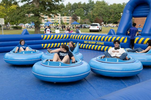Students in blue inflatable bumper cars