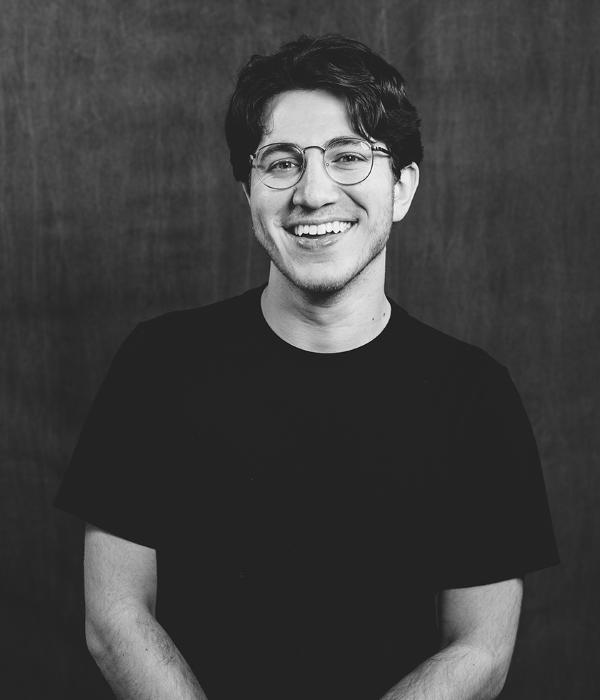 Black and white headshot of art alum Anthony.