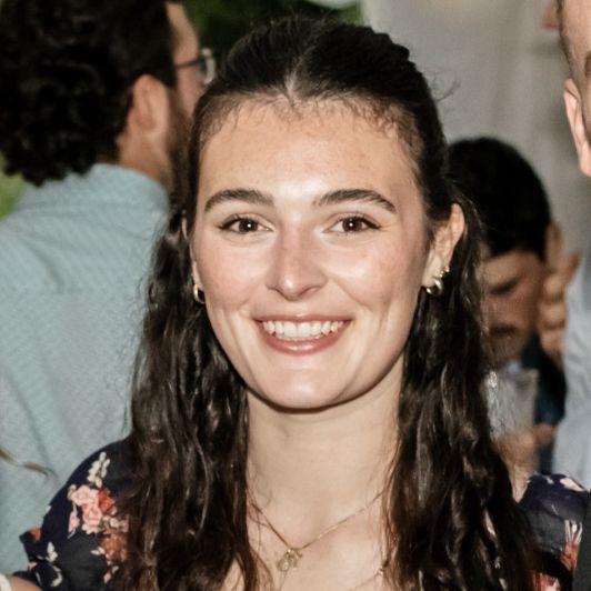 Art alum Melissa smiling wearing a floral shirt.