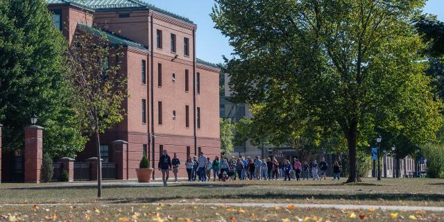 Campus Open House with students walking on the campus green.